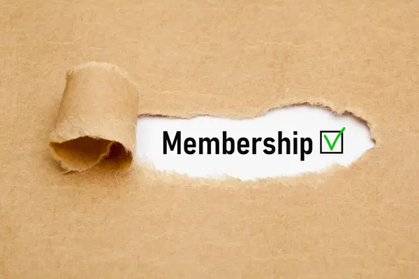 stock image The word Membership with green verification check mark appearing behind torn brown paper.