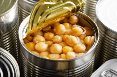Canned chickpeas in just opened tin can. Non-perishable food clipart