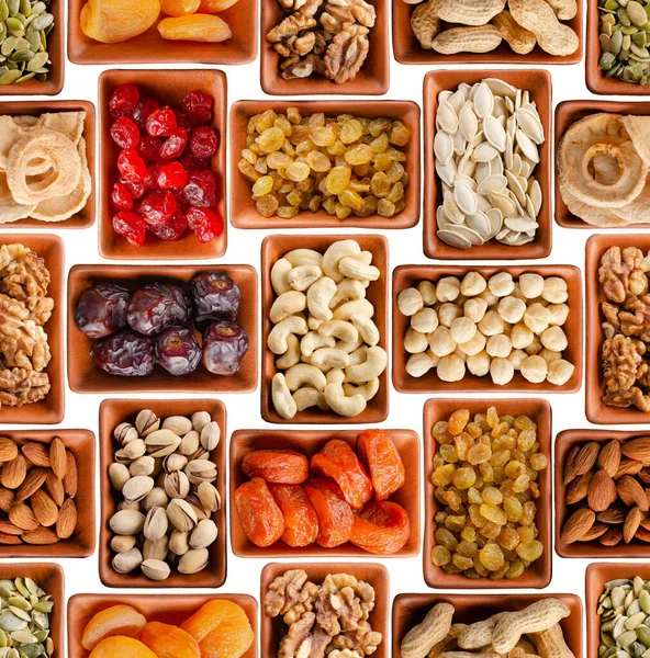 Seamless flat lay food background of dehydrated fruits, seeds and nuts on white. Non-perishable antioxidant gluten free foods concept