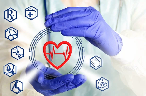 Heart symbol in protecting hands medical symbols background with doc\'s palms in blue gloves