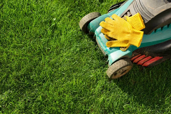 stock image Lawn mower on grass closeup view. Lawn care concept