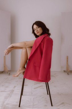Fashion Portrait of stylish girl. Beautiful model European girl posing in a casual clothes in the studio. Female body and style concept.