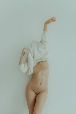 Cheerful woman standing on white background. Nude makeup, perfect skin, long hair. White background. No focus blurred and noise effect