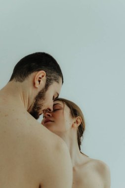 Cheerful woman and man standing on white background. Body positive young couple of lovers. No focus blurred and noise effect