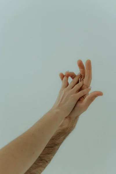 男人和女人牵着手 人类的手放在浅色背景上 友谊和爱的概念 — 图库照片