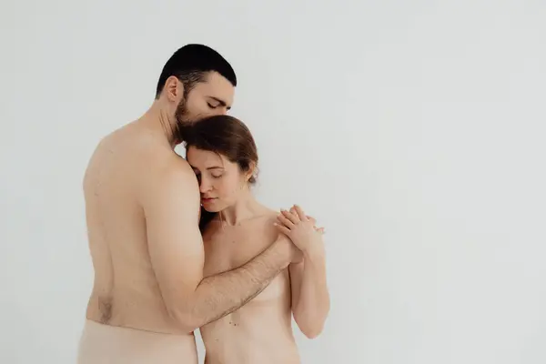Cheerful woman and man standing on white background. Body positive young couple of lovers. No focus blurred and noise effect.