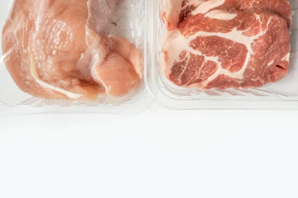 Fresh raw meat in package in plastic box, Close-up of meat in plate over light background.