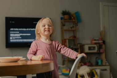 Oyun odasında oyuncaklarla oynayan mutlu bebek portresi. Oyun odasında iki yaşında sevimli bir kız. Üretim alfa kavramı.