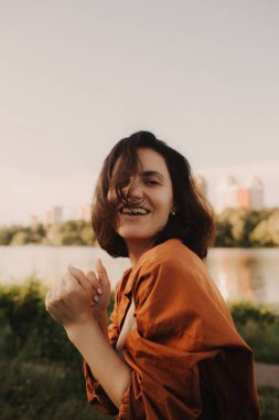 Çevresindeki yeşil, güzel orman ormanlarının tadını çıkaran aşırı mutlu bir kadın. Kadın ve sağlıklı doğal yaşam tarzı kavramı. Dizinin bir parçası.