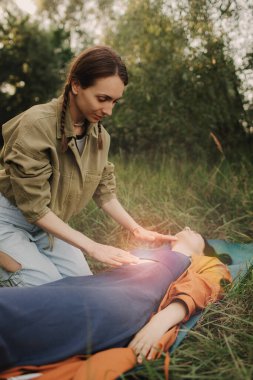 Female energy massage relaxing and care treatment for body and mind full health gentle woman arms holding head doing access bars. Unity with nature and wellness concept. Part of the series.