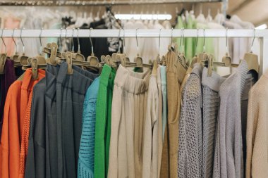 Perakende mağazasında farklı renklerde moda kıyafetleri seçiyor. Geri Dönüşüm Konseptini Azalt. Yatay fotoğraf.