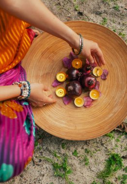 Close-up Indian Woman in traditional saree hand lighting Diya lamp during Diwali festival. Happy greeting photo. Part of a series. clipart