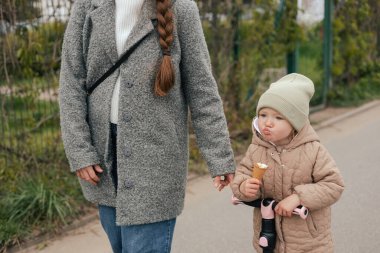 Anne kızına dışarıda motosiklet sürmeyi öğrenirken destek oluyor, yakın plan. Tek başına ebeveynlik ve çocuk yetiştirme kavramı. Bir serinin parçası