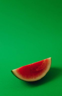 Fresh watermelon on green background. Healthy raw food, dessert without sugar and flour. For text and articles on health. The concept of zero waste, pesticide-free and eco-friendly clipart