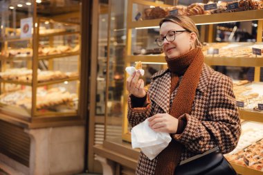 Gen Z orta yaşlı kadın Lizbon 'da fırın yakınlarında Pastel de Nata adında Portekiz yumurtalı tart tatlısı deniyor. Yalnız turizm ve seyahat. Bir serinin parçası