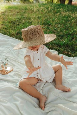 Güneşli bir parkta oynayan mutlu küçük kız. Çocukluk sevinci, Anneler Günü, açık hava aktivitesi, erken öğrenme, hayal gücü, otantik an, duygusal çocukluk, doğal ışık. Bir serinin parçası.