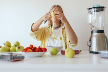 Mutfağında sağlıklı bir son sınıf öğrencisi var. Evde kendine sağlıklı vejetaryen yemekleri servis eden olgun bir kadın. Yaşlı vücuduna bakan bir kadın bitkisel beslenir..