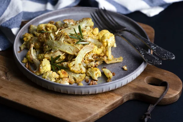 stock image baked cauliflower on a black background. french cuisin