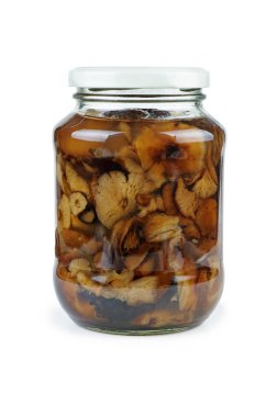 Glass jar with pickled (marinated) honey fungus (mushrooms) isolated on white background