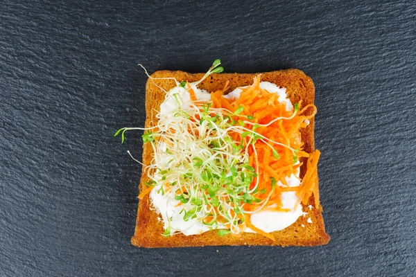 Green Alfalfa Sprouts Grated Carrots Toasted Slices Wholegrain Bread Black — Stok fotoğraf