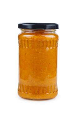 Glass jar with zucchini passte (caviar de courgettes) isolated on white background