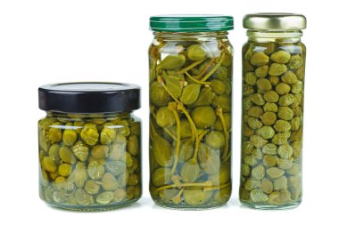Glass jars with marinated capers isolated on the white background