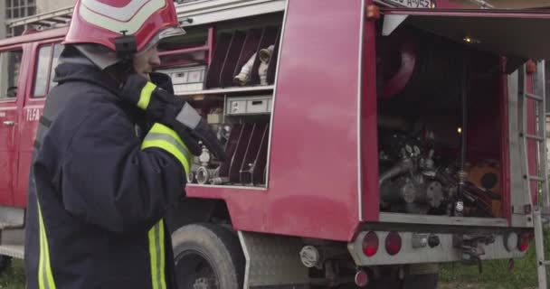 Пожежник Захисною Уніформою Шоломом Стоїть Перед Пожежником Рятувальної Вантажівки Під — стокове відео