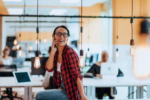 stock image Female boss, manager executive posing in a modern startup office while being surrounded by her coworkers, team