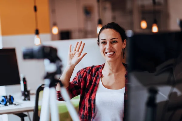 stock image A young woman using a camera to present her business with online clients.