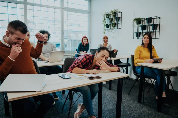 stock image A group of diverse people listen to a lecture in business training while sitting in a modern classroom. High quality photo