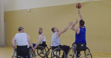 Tekerlekli Sandalye Basketbol Oyunu: Oyuncular Yarışıyor, Top Sürüyor, Pas Veriyor, Atış Yapıyor ve Gol Atıyor. Özürlü İnsanların Kutlanması. Sinematik Ağır Çekim. Kapsama konsepti. Yüksek kalite 4K