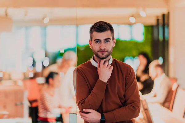 stock image Handsome young businessman standing confident in the office in front of his team. High quality photo