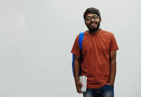 Indyjski Student Niebieskim Plecakiem Okularami Notatnikiem Pozującym Szarym Tle Koncepcja — Zdjęcie stockowe