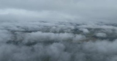 Dağlarda yağışlı hava. Çam ağacı ormanında sisli bir sis esiyor. Sisli bir günde dağ tepelerindeki ladin ormanlarının hava görüntüleri. Soyut kopyalama alanı doğal arkaplan. Merhaba kalite 4K