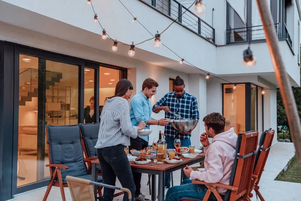 Group Young Diverse People Having Dinner Terrace Modern House Evening — Stock Photo, Image