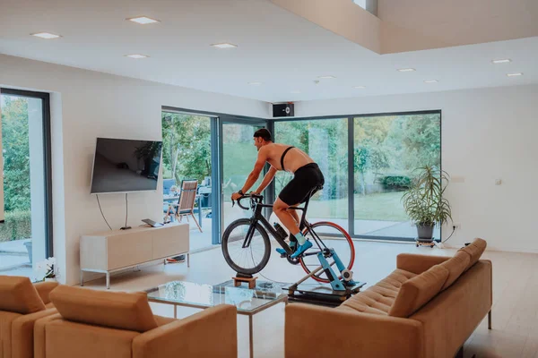 Homme Vélo Triathlon Sur Une Simulation Machine Dans Salon Moderne — Photo