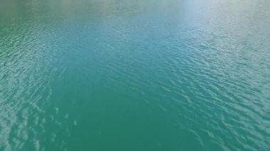 Bir dağ ormanında turkuaz su. Mavi soyut arkaplan açılış sahneleri. Kristal berrak dağ gölü suyu. Temiz su. Sinematik döngü arka planı. Yüksek kalite 4k görüntü