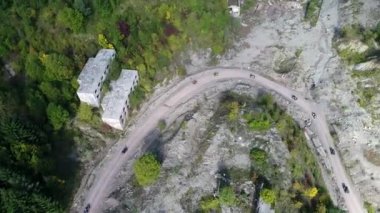 Ormanlardaki toprak bir patikada ATV kuadlarının hava aracı görüntüsü. Off-road grubu kulüp meraklıları kırsal yollarda araba sürerken eğleniyorlar. Yüksek kalite 4k görüntü