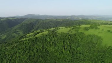 Sonsuz bir dağ ve orman manzarasının sinematik görüntüsü. Gün batımında Dağ 'daki tepelerin üzerinden uçacağız. Merhaba kaliteli 4K görüntüler.