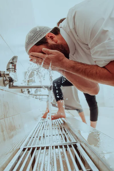 A Muslim performing ablution. Ritual religious cleansing of Muslims before performing prayer. The process of cleansing the body before prayer.