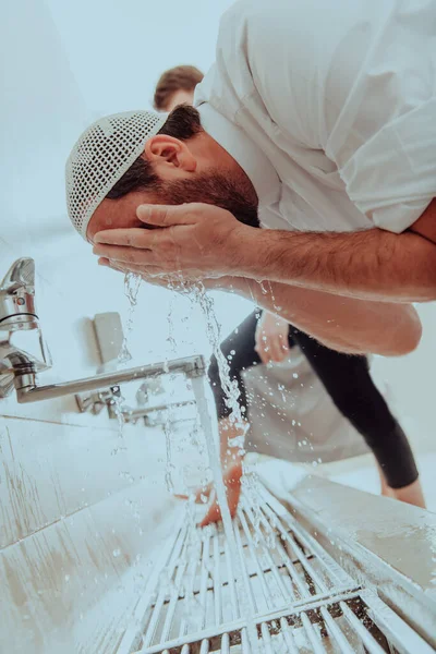 A Muslim performing ablution. Ritual religious cleansing of Muslims before performing prayer. The process of cleansing the body before prayer.
