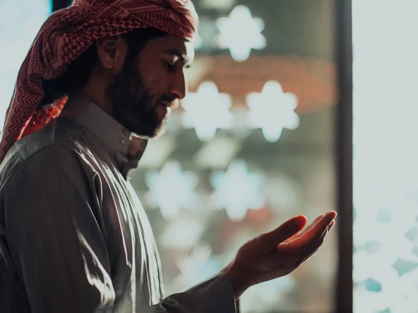 Muslim Arabic man praying. Religious muslim man praying inside the mosque during ramadan. High quality photo