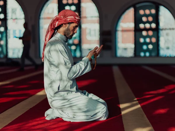 Muslim Arabic man praying. Religious muslim man praying inside the mosque during ramadan. High quality photo