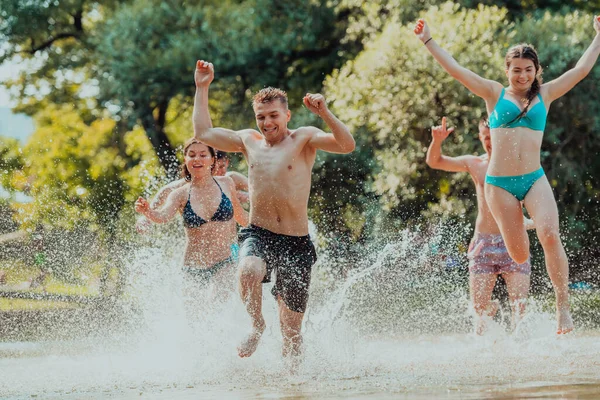 Group Diverse Young People Having Fun Together Run River Play — Stok fotoğraf