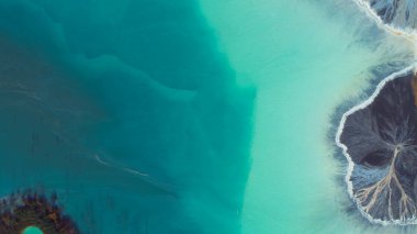 Top down aerial view over natural texture - abstract industrial lake water patterns. Turquoise waternature poluttion. Hi quality 4K footage. 