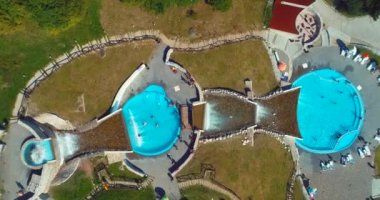 Aerial drone view of overcrowded urban lake during peak of tourist season. Crowd of people swimming in the sea at summer. Large group of people in swimsuit bathing in ocean during vacation. High