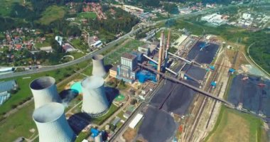 Aerial view of coal power plant high pipes with black smoke moving up polluting atmosphere at sunny day. High quality 4k footage