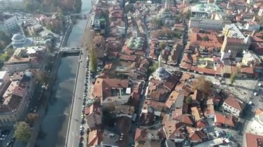 Saraybosna ve ulusal kütüphanenin hava görüntüleri, gün batımında Saraybosna kenti manzaralı Vijecnica kütüphanesinin üzerinde uçuyor. Yüksek kalite 4k görüntü