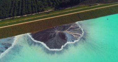 Top down aerial view over natural texture - abstract industrial lake water patterns. Turquoise waternature poluttion. Hi quality 4K footage. 
