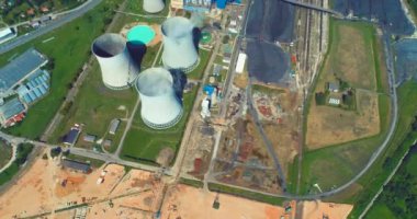 Aerial view of coal power plant high pipes with black smoke moving up polluting atmosphere at sunny day. High quality 4k footage